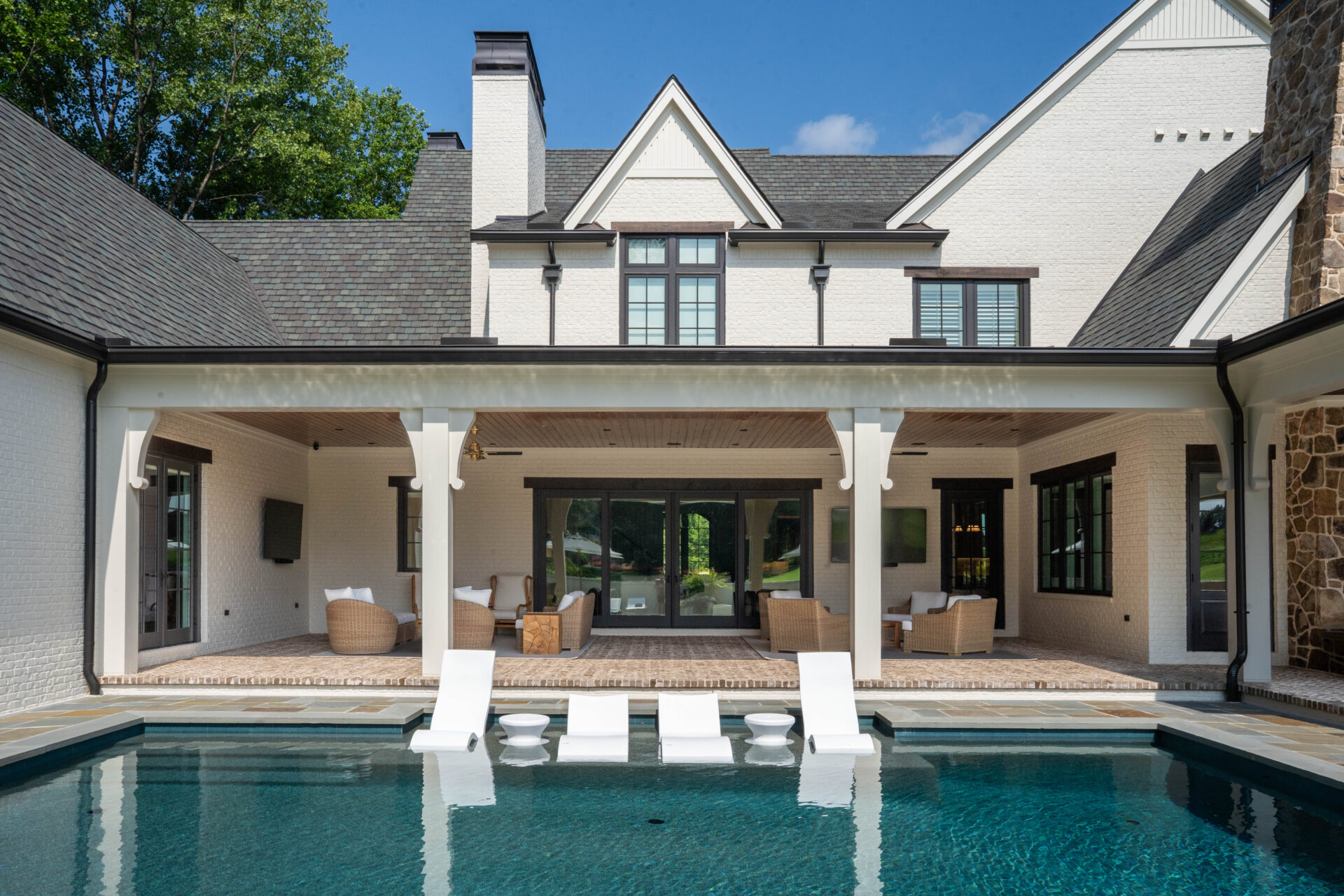 Rear of a custom home built by Robert Long Construction, with pool and covered outdoor living